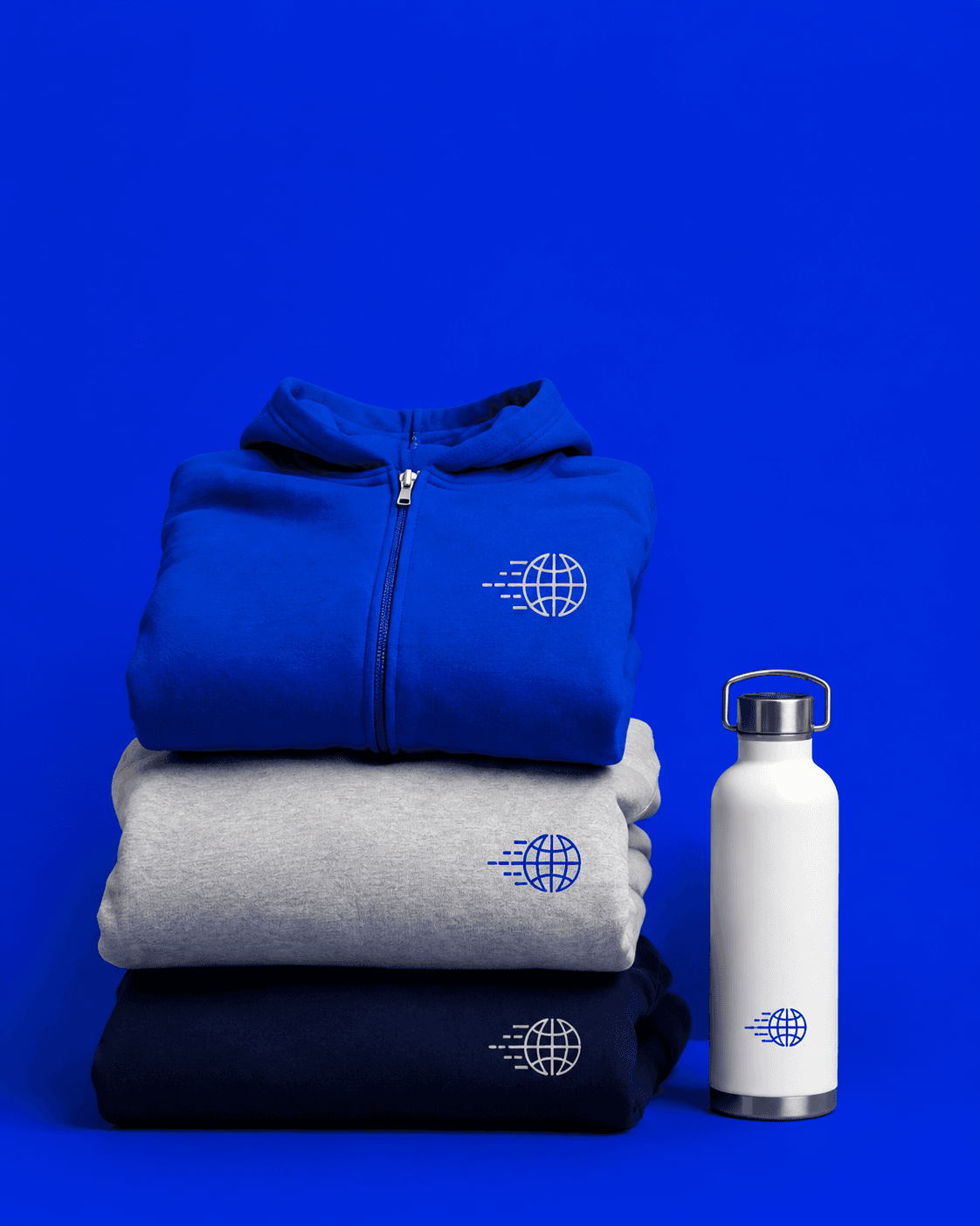 Stack of coordinated custom hoodies and a bottle against a blue backdrop